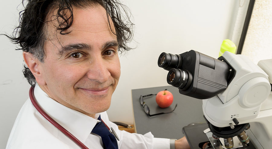CHÉOS Scientist Dr. Kamran Shojania using a microscope